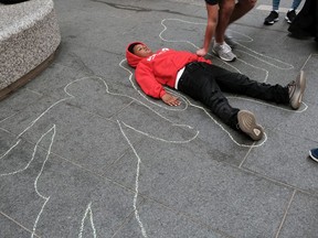 Local teenagers participate in a "Die In" to draw attention to gun violence on April 14, 2022 in Philadelphia, Pennsylvania.