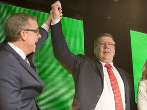Premier Brad Wall holds up Premier elect Scott Moe's arm after Moe won the Saskatchewan Party leadership during the Saskatchewan Party Leadership Convention in Saskatoon, SK on Saturday, January 27, 2018.