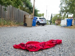 A red bandana lays unattended in the middle of an alley as police investigate a home that was the scene of a SWAT call on Connaught Street in August of 2018.