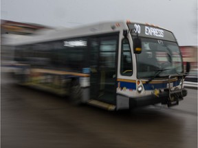 A city transit bus speeds along 11th Avenue.