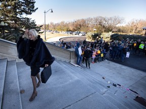 Now Saskatchewan United Party leader supporter Nadine Wilson being cheered by anti-vaccine protestors as she walks up the steps of the legislature last year.