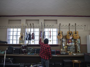 Pawn star falling: How the pandemic and rising tech killed a Regina staple 3 A shopper examines guitars at City Collateral pawn shop on Mar. 29.
