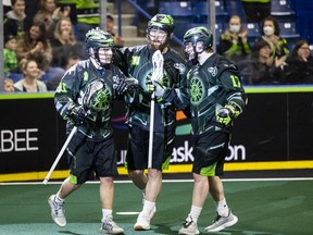 Saskatchewan Rush forward Dan Lintner (41) is congratulated by defender Mike Messenger (8) and forward Robert Church (17) after his first-period goal against the Colorado Mammoth on Saturday.