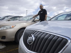 Pardeep Kumar who offers rideshare services in Regina stands for a portrait beside his vehicle on Monday.