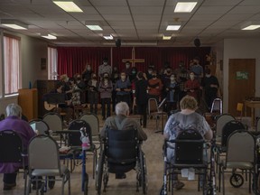 Students with Luther College High School sing to seniors at Mutchmor Lodge during the schools annual Service Day on Wednesday, April 27, 2022 in Regina. The event captured the dichotomy of the province's population — with a young cohort among the seniors.