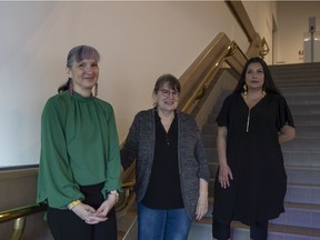 LtoR) Cathy Mattes, Sherry Farrell Racette and Michelle LaVallee pose for a portrait in front of the entrance to a collection of installations entitled Radical Stitch, a seminal exhibition of contemporary Indigenous beadwork.