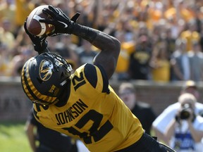 Johnathon Johnson, shown catching a touchdown pass for the University of Missouri Tigers in 2017, has signed with the Saskatchewan Roughriders.