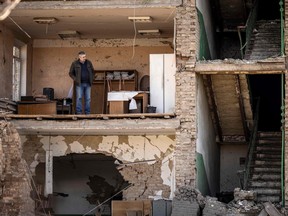 A man stands in a building with a collapsed facade at the Vizar company military-industrial complex, after the site was hit by overnight Russian strikes, in the town of Vyshneve, southwestern suburbs of Kyiv, on April 15, 2022.