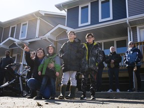 Angela Stulberg, left, points while her children look on during a press conference at Habitat for Humanity's Haultain Crossing project on 10 block Edgar Street.