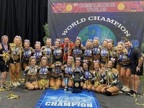 Members of Regina's Rebels Cheerleading Athletics' Smoke team celebrate after winning the International Open Level 5 title at the Cheerleading Worlds in Orlando, Fla., on Monday.