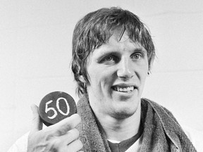Mike Bossy holds a puck signifying the production of 50 goals in his first 50 games of the 1980-81 NHL season. Bossy, one of hockey's most prolific goal-scorers and a star for the New York Islanders during their 1980s dynasty, died Thursday after a battle with lung cancer. He was 65.