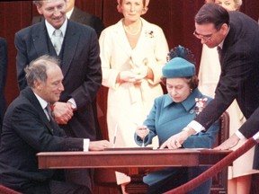Queen Elizabeth II signs Canada's constitutional proclamation in Ottawa on April 17, 1982, as Prime Minister Pierre Trudeau looks on. The Constitution Act 1982 included the Charter of Rights and Freedoms.