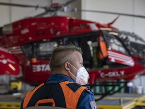 Critical care nurse Darren Entner stands in front a Airbus H145 helicopter during a tour of the Regina STARS Base on April 28, 2022 in Regina. The tour is part of the 10 year anniversary celebrations of the service.