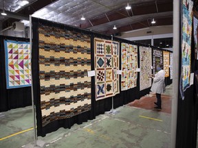 A judge puts on tags that notes "performance" as volunteers prepare an upcoming quilt show, held Friday and Saturday at Callie Curling Club hosted by the Prairie Piecemakers Quilter's Guild. The phone was taken on Thursday, May 5, 2022 in Regina.