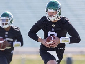 Quarterback Jake Dolegala, right, performs a drill during the Saskatchewan Roughriders' rookie camp Wednesday at Griffiths Stadium in Saskatoon.