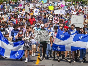 Demonstrators walk down Atwater Ave. during a rally to oppose Bill 96 in Montreal on Saturday, May 14, 2022.