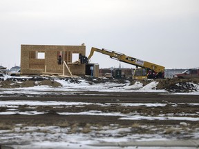 A construction worker works on a house in Regina's east end on Tuesday, December 14, 2021. The Saskatchewan Housing Contiuum Network says more homes need to be built in Saskatchewan in the next eight years than have been built in the last three decades to meet demand from population growth.