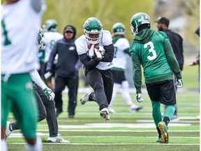Saskatchewan Roughriders running back Jamal Morrow  takes to the air while completing drill during the Green and White's main training camp on Friday.