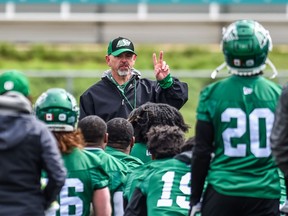 Saskatchewan Roughriders head coach Craig Dickenson (centre) was pleased to be on the turf on Friday.