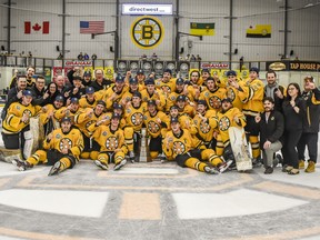 The Estevan Bruins celebrate on Friday at Affinity Place after winning the SJHL championship.