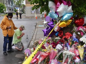 People visit a makeshift memorial set up outside the Tops supermarket on May 18, 2022 in Buffalo, New York