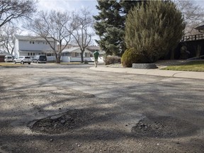 Broken pavement and potholes are shown on Mayfair Crescent on Monday, May 2, 2022 in Regina. Mayfair Crescent tops the CAA's list of worst roads in Saskatchewan (as voted on online).