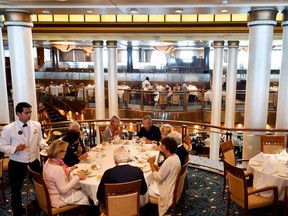 Passengers eat lunch in a restaurant aboard the Cunard cruise liner RMS Queen Mary 2, sailing in the Atlantic Ocean in 2017.