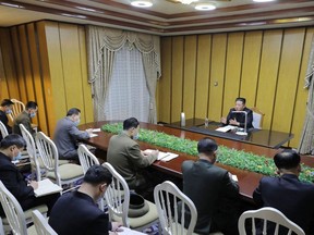 This picture taken Thursday, May 12, 2022 and released from North Korea's official Korean Central News Agency on May 13 shows North Korean leader Kim Jong Un (right) inspecting the National Emergency Quarantine Command at an undisclosed location in North Korea.
