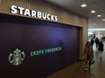 A woman walks past a closed Starbucks cafe in central Saint Petersburg, Russia, Monday, May 23, 2022.