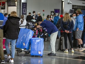 People line up at Toronto Pearson International Airport on May 3, 2022.