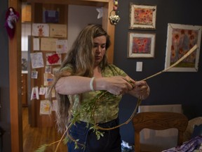 Melanie Monique Rose, curator of a multimedia art installation titled ᑌᐸᑯᐦ, or Tepakohp, makes a willow wreath for the show at her home Wednesday, May 18, 2022 in Regina.