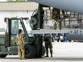 Airmen unload pallets from the cargo bay of a U.S. Air Force C-17 carrying 78,000 lbs of Nestle baby formula from Europe at Indianapolis Airport on May 22, 2022 in Indianapolis, Indiana.