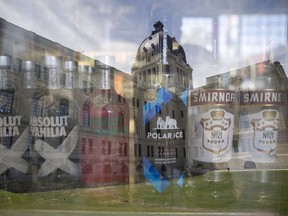 An in-camera double exposure of liquor from a store is superimposed over an image of the Saskatchewan Legislative Building.