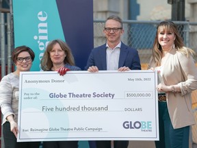 Left to right: Jocelyne Lang (Globe board member and public campaign chair), Jennifer Brewin (artistic director), Trevor Boquist (chair, reimagine campaign), and Jaime Boldt (executive director) hold up a $500,000 cheque Wednesday during a media gathering outside Globe Theatre at 1801 Scarth St. The money will go toward renovations to the theatre. Photo by Strategy Lab Marketing.