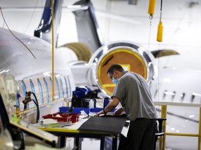 A Bombardier employee works on final touches to a jet in Montreal, March 29, 2022. Canada's aircraft sector is particularly vulnerable to the luxury tax, an industry insider says.