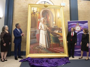 Lieut.-Gov. Russ Mirasty, second from left, along with his wife Donna, left, were joined by artist Phil Richards, third from left, and his wife Jennifer, right, for the unveiling of the 10-foot tall Diamond Jubilee Portrait of Her Majesty Queen Elizabeth II. at Government House on Thursday, May 19, 2022 in Regina. The portrait was painted by Richards in celebration of Her Majesty Queen Elizabeth II's Diamond Jubilee and was officially unveiled in London, UK, on June 6, 2012, and installed in Rideau Hall, Ottawa on June 28, 2012. It will be on display at Government House in Regina until March 2023.