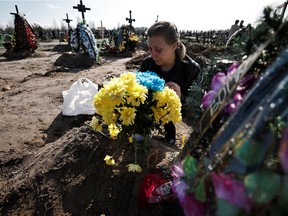 Irina Tromsa, 50, who said her son Bohdan Tromsa, 25, a territorial defence member, was killed by Russian troops on the frontline near Sumy, mourns by his grave day after his burial at the cemetery in Bucha, amid Russia's invasion of Ukraine, Kyiv region, Ukraine April 24, 2022. REUTERS/Zohra Bensemra