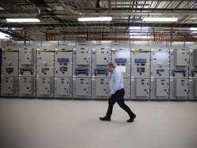 Buffalo Pound Water Treatment Corporation CEO Ryan Johnson walks past a controlled rom for a generator during a tour of the plant on May 26, 2022.