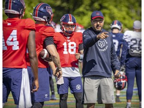 Montreal Alouettes quarterbacks coach Anthony Calvillo, left, is shown at the CFL team's training camp in May.