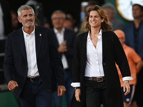 Roland-Garros Open tennis tournament's director Amelie Mauresmo, right, and President of the French's Tennis Federation Gilles Moretton, left, arrive to attend a ceremony to greet France's Jo-Wilfried Tsonga at the end of his men's singles match against Norway's Casper Ruud on Day 3 of the Roland-Garros Open tennis tournament at the Court Philippe-Chatrier in Paris on May 24, 2022.