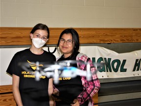 Martha McGoniguru (left) and Chloe de Jare, students of Rossignol High School in Il Alacross, Saskatchewan, learn to fly a drone on June 18, 2022.