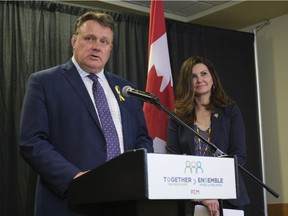 Halifax Mayor Mike Savage, left, speaks while Regina Mayor Sandra Masters, looks on at a Federation of Canadian Municipalities press conference, speaking on economic recovery and the housing crisis.