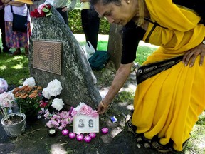 FILE PHOTO: Jagada Venkateswaran places flowers on photographs of her niece and sister-in-law, both who were killed in the Air India Bombing, at a 2009 memorial ceremony in Toronto.