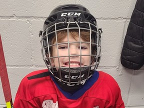 Benjamin Dufour smiles for the camera in hockey gear in this handout photo.