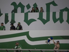 A lone Blue Bombers fan waves a jacket during the second half of CFL action at Mosaic Stadium during the exhibition game between the Saskatchewan Roughriders and Winnipeg Blue Bombers on Tuesday, May 31, 2022 in Regina.