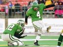 The Roughriders' Paul McCallum, with Keith Smith holding, kicks a CFL-record 62-yard field goal against Edmonton at Taylor Field on Oct. 27, 2001.