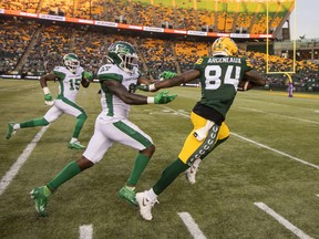 Saskatchewan Roughriders' Rolan Milligan, 0, chases Edmonton Elks receiver Manny Arceneaux, 84, on a play that resulted in a 66-yard gain on Saturday night.