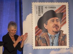 Cheryl Storkson, widow of Harry Daniels unveils a stamp with of portrait of her late husband and Métis leader Harry Daniels at the Delta hotel on Monday, June 13, 2022 in Regina. Canada Post will issue a new set of stamps paying tribute to the lives and legacies of three Indigenous leaders. Harry Daniels, Chief Marie-Anne Day Walker-Pelletier and Jose Kusugak will each be featured on a stamp in recognition of their incredible commitment and contributions to strengthening the Métis, First Nations and Inuit communities they served.