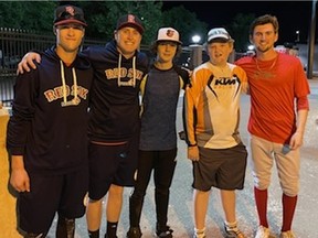 Regina Red Sox players Kendall Keller (left), Bryson Sanchez (second from left) and Zane Pollon (far right) pose with Luke Dahlman (Baltimore Orioles hat) and Tyson Dahlman after a Western Canadian Baseball League game in Medicine Hat last weekend.