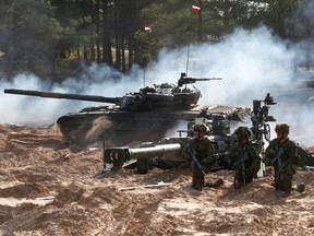 A Canadian Army M777 hotwitzer and Polish Army T-72 tank participate in the Silver Arrow 2020 military exercise in Adazi, Latvia.